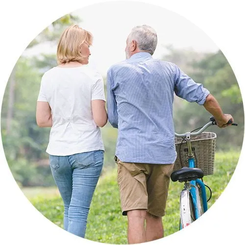 elderly man walking with his daughter and offering financial advice